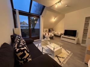 a living room with a couch and a tv at Schloss Appartement in Paderborn