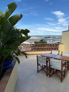 a table and chairs on a balcony with a view of the ocean at Dúplex amb vistes al mar 150 mts to Nautical Club Christmas R in Palamós