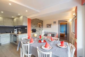 a kitchen and dining room with a table and chairs at Appartement spacieux 6 personnes in Le Grand-Bornand +13 photos