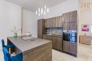 A kitchen or kitchenette at Stylish 3BR home with large terrace in Mosta by 360 Estates