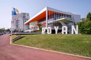 a building with a large sign in front of it at Best Western Hôtel Royan Océan in Royan