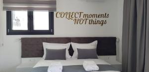 a bed with a sign that reads correct memory not things at Aeonian Luxury Suites Asprovalta, Adults Only & Kids 12 Plus in Asprovalta