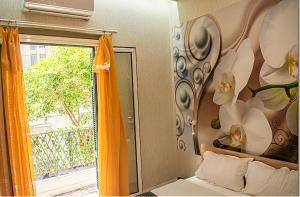 a bedroom with a mirror and a door with a window at Ayasofia Suite jakuzzi 2 BedRooms balcony in Thessaloniki