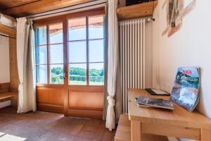 a room with a wooden table and a window at Agriturismo Dolce Colle in Volpago del Montello