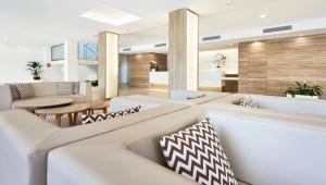 a living room with white furniture and a dining room at Globales Costa de la Calma in Santa Ponsa +65 photos