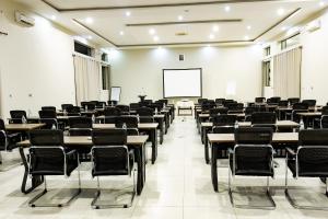 an empty classroom with tables and chairs and a whiteboard at Sigelege Beach Resort in Senga