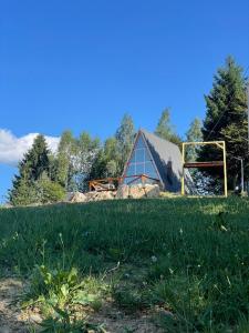 a field with a barn and a soccer goal at Valea Lui Neag in Cîmpu lui Neag +10 photos