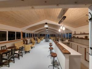a large dining room with tables and chairs at Valea Lui Neag in Cîmpu lui Neag