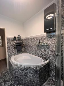 a bathroom with a large tub in a room at Villa GiNa Apartement in Albbruck