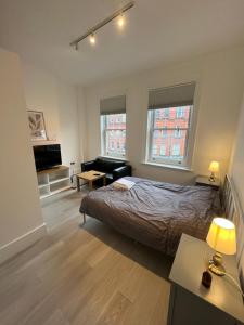 a bedroom with a bed and a living room at Camden BNB in London