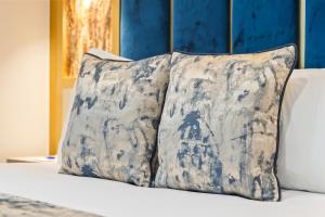 two pillows are sitting on top of a bed at Hotel Holloway in Birmingham +23 photos