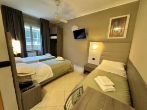 Postel nebo postele na pokoji v ubytování Hotel Parma