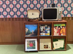 a display case with a tv and books at The Très Hotel in Kuala Lumpur