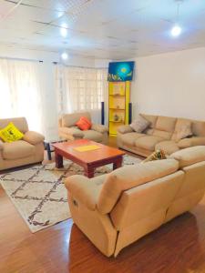 a living room with couches and a coffee table at Evergreen Kile homes in Nairobi