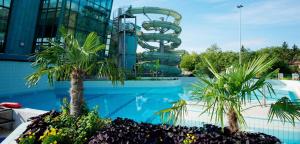 a water park with a water slide in the background at Villa Gran in Esztergom
