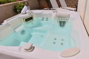 a jacuzzi tub with a hat in it at Villa Erna Relax Dream Holiday in Callao Salvaje +73 photos