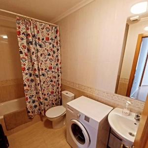 a bathroom with a toilet and a shower curtain at S&H La Consentida in San Juan de los Terreros +19 photos