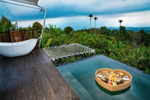 a bathroom with a bath tub and a bowl of food at Harsa Eco Luxury Camp in Gobleg