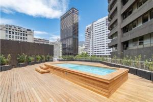 a rooftop deck with a swimming pool on a building at One Thibault Hotel - Sea View Studio - Near CTICC & V&A Waterfront in Cape Town
