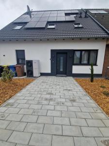 a house with solar panels on the roof at New & Modern Apartment near Düsseldorf in Willich
