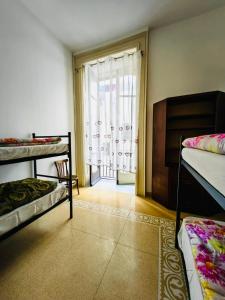 Postel nebo postele na pokoji v ubytování Salerno Experience Hostel
