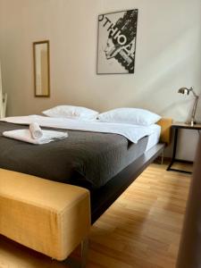 a bedroom with a large bed and a chair at VELVET apartment in Weimar