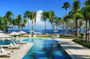 a swimming pool with lounge chairs and palm trees at Villa Granada at Dorado Beach Resort pool nearby in Dorado