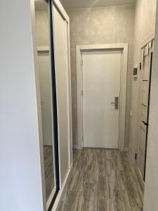 an empty hallway with a door and a mirror at Snowy Pines Gudauri Alpic Ski Resort in Gudauri +21 photos