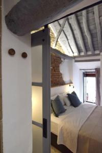 a bedroom with a bed in a room with a ceiling at El Capricho in Ronda
