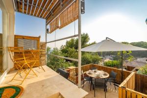 a patio with a table and an umbrella at Cozy Ocean View Cala Crancs Flat in Salou