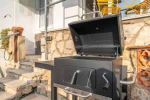 a grill with a television on top of it at Cozy Ocean View Cala Crancs Flat in Salou