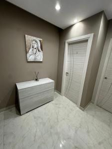a bathroom with a white dresser and a door at Villa Abenante Pompei in Scafati +43 photos