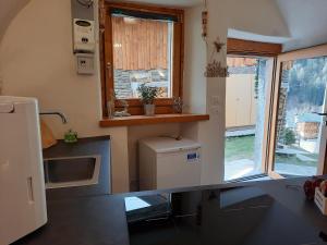 a small kitchen with a sink and a window at Chalet Sweet Mountain in Ponte di Legno
