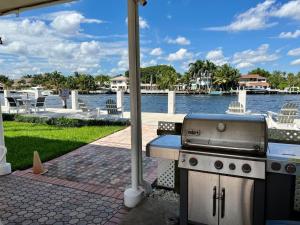 a barbecue grill on a patio next to a body of water at Renovated Intercoastal 2Bdrm 1 bath condo Walk to Beach in Fort Lauderdale
