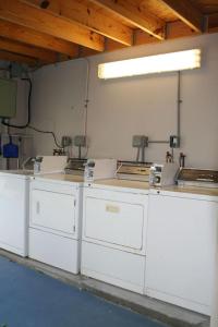 a kitchen with white cabinets and a counter top at Renovated Intercoastal 2Bdrm 1 bath condo Walk to Beach in Fort Lauderdale