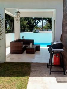 a patio with a grill and a swimming pool at Tropical Paradise Villa in Sosua in Sosúa