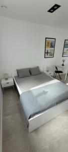 a large bed in a room with two tables at Apartamenty Chojno-Młyn 46 in Chojno