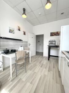 a kitchen with a table and chairs in a room at Keja Rooms II - Pokoje Noclegi w Centrum Gdyni in Gdynia
