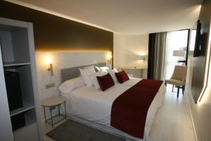 Posteľ alebo postele v izbe v ubytovaní Hotel Cardenal