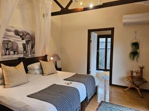 a bedroom with a large bed and a mirror at Thornwood in Hluhluwe +155 photos