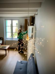 a child is standing in a living room with lights at Clos des Mésanges in Chisseaux