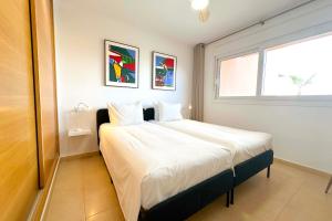 a bedroom with a bed with white sheets and a window at Vista Bonita - Mar Menor Golf Resort in Torre-Pacheco +32 photos