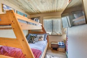 a bedroom with bunk beds in a tiny house at Ski-In Red River Retreat Balcony, Mountain Views! in Red River