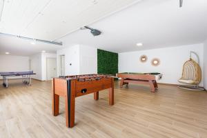 a room with a ping pong table and a pool table at Antica Villa, luxury villa near the beach in Ribamar