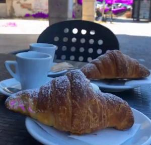two croissants on a white plate on a table at affittacamere da Fenix in Tivoli
