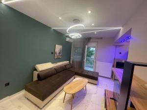 a living room with a couch and a table at Lydia Luxury Apartment by the Sea in Perea