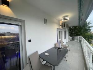 a balcony with a table and chairs on a balcony at Lydia Luxury Apartment by the Sea in Perea