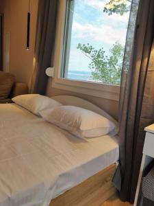 a bed in a room with a window at Lydia Luxury Apartment by the Sea in Perea