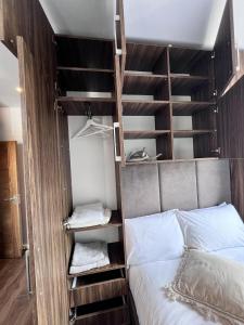 a bedroom with a bunk bed with a ladder next to it at London Studio Retreat - Colney Hatch Lane in London