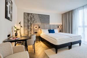a hotel room with a bed and a desk at Citadines Kurfürstendamm Berlin in Berlin +18 photos